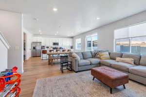 Living room with light hardwood / wood-style flooring and a textured ceiling