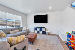 Living room with light hardwood / wood-style floors and a textured ceiling