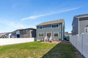 Back of house featuring a yard