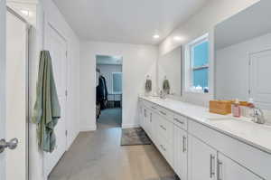 Bathroom featuring tile patterned flooring, vanity, and a shower with shower door