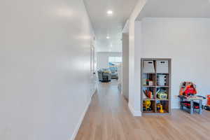 Hall with light hardwood / wood-style flooring