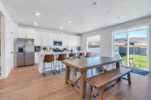 Dining room featuring light hardwood / wood-style floors and a textured ceiling