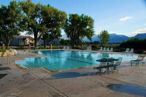 Community pool with a patio area and a mountain view