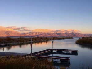 View of dock featuring a water and mountain view