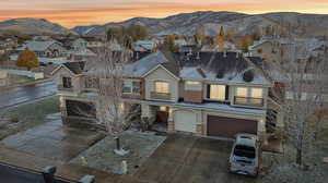 View of front of house with a garage and a mountain view