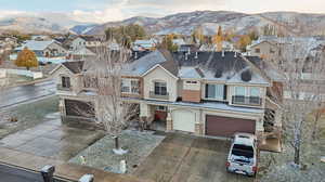 View of front of home with a mountain view and a garage