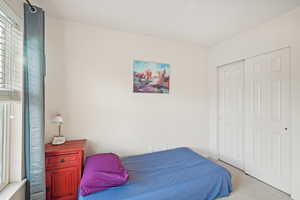 Bedroom with carpet and a closet