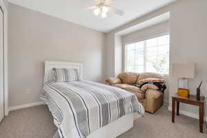 Bedroom featuring ceiling fan and light carpet