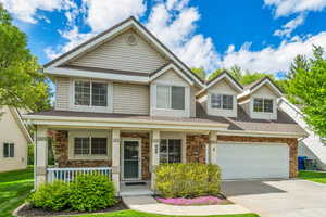 View of front of home with a porch and a garage