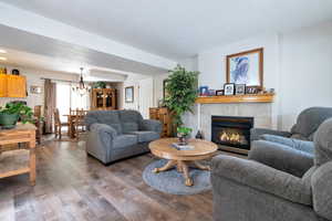 Living room featuring a chandelier, hardwood / wood-style flooring, and a fireplace