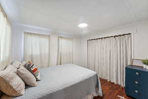 Bedroom featuring dark wood-type flooring