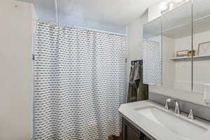 Bathroom with walk in shower and vanity