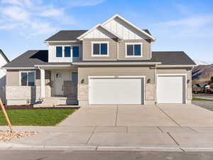 View of front of home with a mountain view and a garage