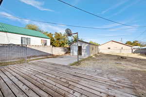 Wooden deck featuring a storage unit