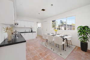 Dining room with sink and light tile patterned floors