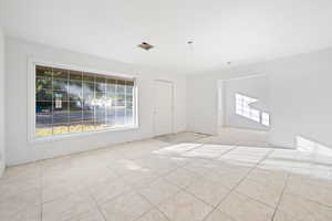 Empty room with light tile patterned floors