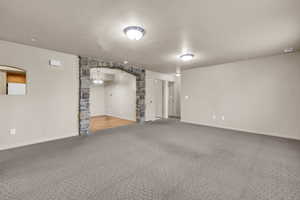 Interior space featuring a textured ceiling and carpet