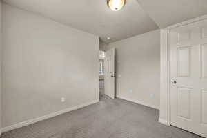 Unfurnished bedroom featuring light colored carpet