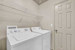 Laundry area featuring washing machine and clothes dryer