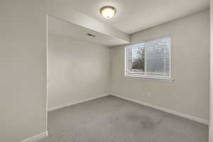 Empty room with carpet flooring