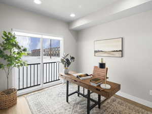 Office space with hardwood / wood-style flooring