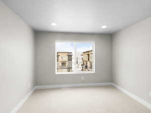 Spare room with carpet and a textured ceiling