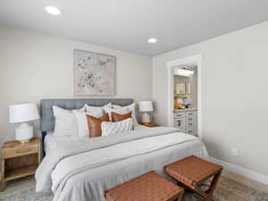 Bedroom with ensuite bath and carpet floors