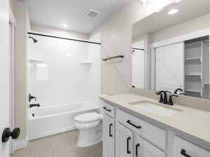 Full bathroom with tile patterned floors, vanity,  shower combination, and toilet