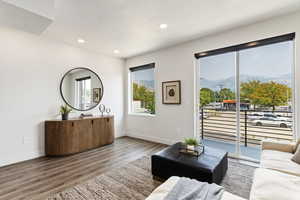 Living room with wood-type flooring, a mountain view, and a textured ceiling