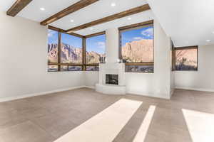 Unfurnished living room with a mountain view and beam ceiling