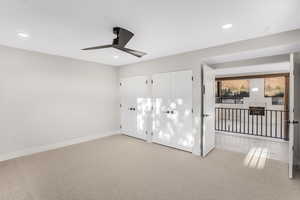 Carpeted empty room with ceiling fan