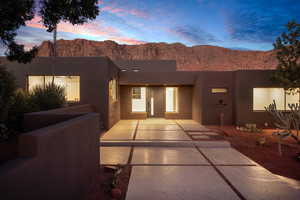 Pueblo-style house with a mountain view and a patio