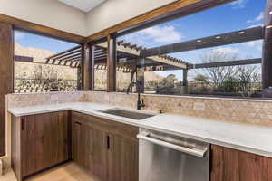 View of patio / terrace featuring a pergola, sink, and a mountain view