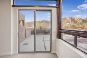 Entryway with a mountain view and light carpet