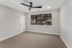 Carpeted spare room with ceiling fan