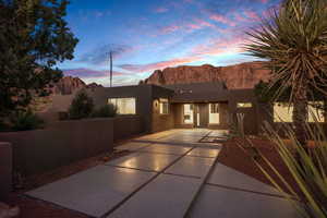 Adobe home featuring a mountain view and a patio