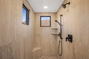 Bathroom featuring tiled shower