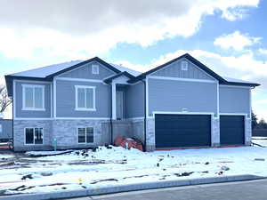 Craftsman house featuring stone siding and board and batten siding