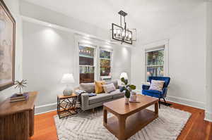 Living room with hardwood / wood-style floors and a chandelier