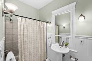 Bathroom with sink and shower / bathtub combination with curtain