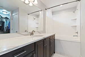 Primary Bathroom with vanity, tile patterned flooring, and shower / bathtub combination