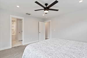 Primary Bedroom with ceiling fan and connected bathroom