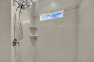 Bathroom featuring a tile shower