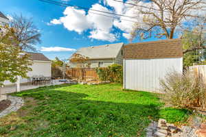 View of yard with a shed and a patio area