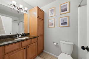 Bathroom with tile patterned flooring, vanity, and toilet