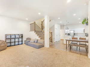 Living room featuring sink and light hardwood / wood-style flooring