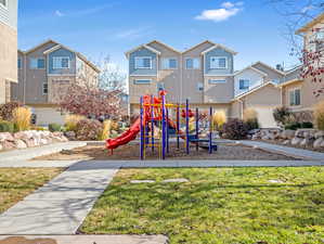 View of playground with a lawn