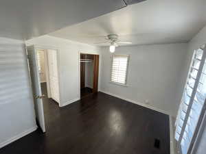 Unfurnished bedroom with a closet, ceiling fan, and dark hardwood / wood-style floors