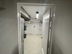 Hallway featuring water heater/ Laundry room