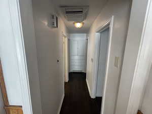 Hallway with dark wood-type flooring